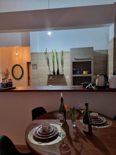 a table in a kitchen with two bottles of wine at Ape da Deisi Termas in Gravatal
