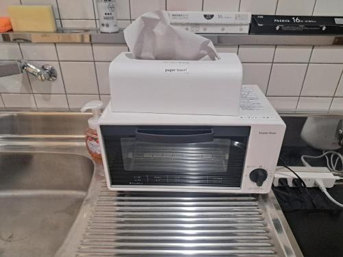 a toaster oven sitting on top of a kitchen counter at 2 minutes from Oyama station, 2 beds in Oyama