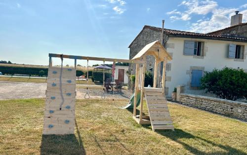 a playground with a climbing frame and a slide at La Barauderie , chambre individuelle in Mazeray