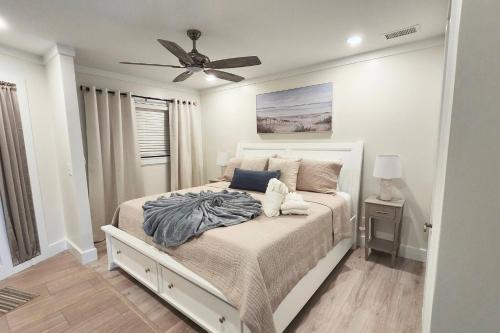 a bedroom with a bed with a ceiling fan at Southern Serenity, an HHI Beachfront Resort in Hilton Head Island