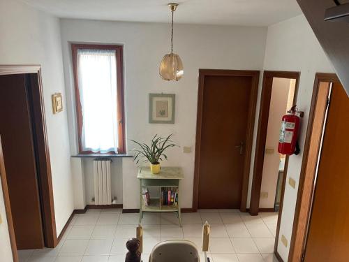 a living room with a window and a table with a plant at La Terrazza al Forte in Forte dei Marmi