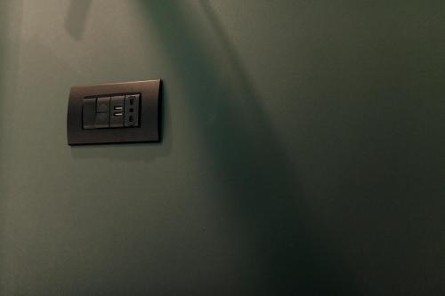 a lightswitch on a wall in a room at CefaLux - Apartments in Cefalù