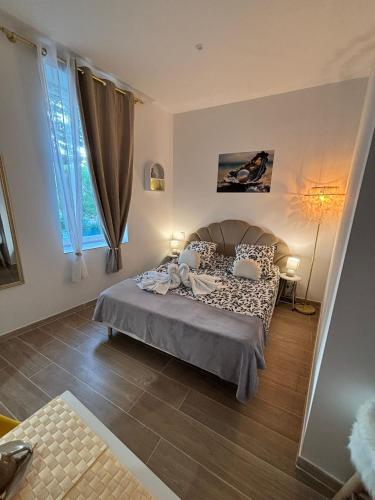 une chambre avec un lit et une grande fenêtre dans l'établissement La Perle, à Narbonne