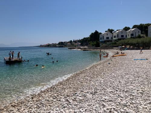 a group of people in the water at a beach at Apartment Andrea in Sutivan