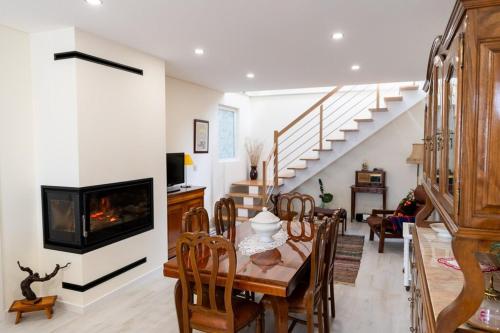 a living room with a dining table and a fireplace at Casa da Tapada in São João da Pesqueira
