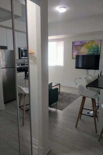 a living room with a table and a mirror at GGP Boutique Townhome in Vaughan