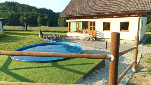 a large blue pool in front of a house at Sjezdovka Bušín in Busin