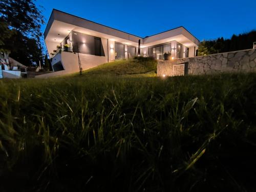 a house on top of a hill at night at Rent Your Family Retreat in Novi Sad in Novi Sad