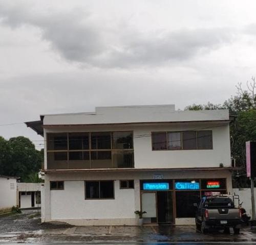 a building with a truck parked in front of it at Hotel Pensión Galicia in Obaldía
