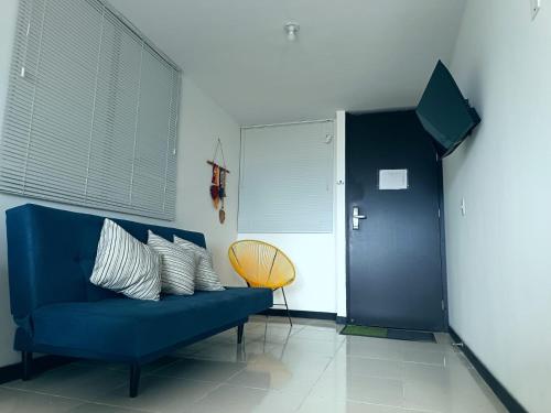 a blue couch with white pillows in a room at Gaia512A in Montenegro