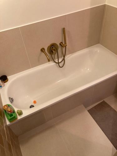 La salle de bains est pourvue d'une baignoire blanche. dans l'établissement Beautiful kids friendly apartment with Montmartre view, à Paris