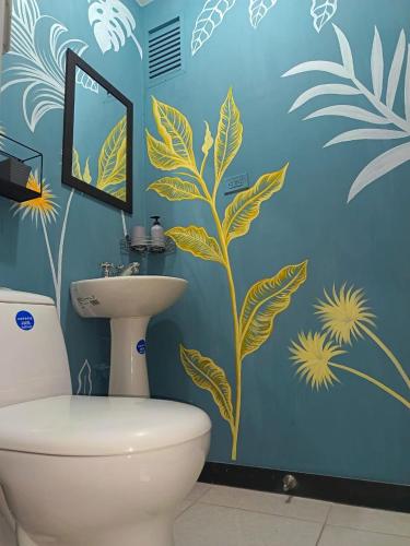 a bathroom with a toilet and a blue wall at Gaia512A in Montenegro