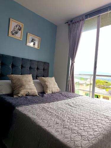 a bedroom with a large bed with a large window at Gaia512A in Montenegro