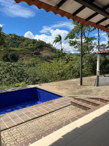 a swimming pool with a view of a hill at Finca de Majo in Mocoa