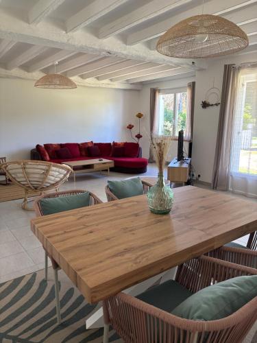 un salon avec une table et des chaises en bois dans l'établissement Maison 3 chambres avec jardin, à Eymet