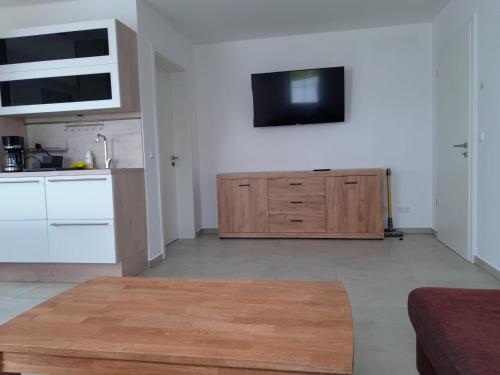 a kitchen with a sink and a wooden cabinet at Marktperle in Sagard