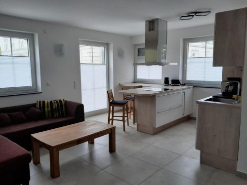 a kitchen and living room with a couch and a table at Marktperle in Sagard