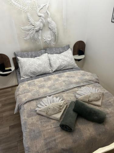 a bedroom with a large bed with two towels on it at Angelina Art in Trnava