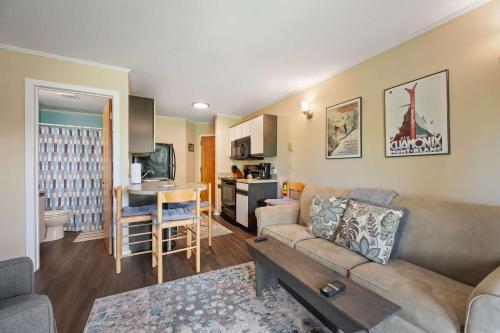 a living room with a couch and a table in a room at Cozy 1 Bedroom Condo Holiday Valley in Ellicottville