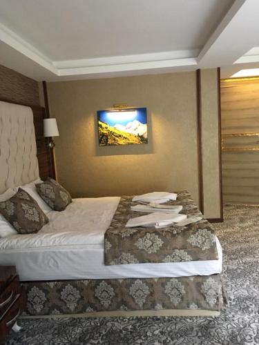 a hotel room with a bed with towels on it at Ayder Hasimoglu Hotel in Ayder Yaylasi