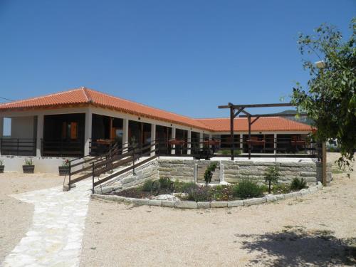 a building with a porch and a patio at Agroturizam Duvančić - Konoba dida Marka in Drniš