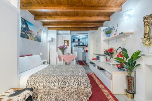 a bedroom with a large bed and a kitchen at Diana Romantic Loft in Rome
