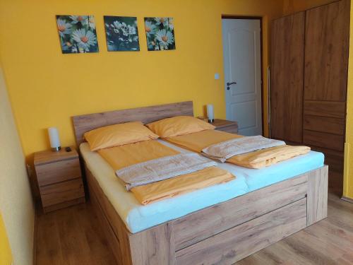 a bedroom with a bed with two pillows on it at Bodza apartman in Gyula