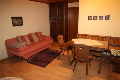 a living room with a couch and a table at Pension Central in Bad Endbach