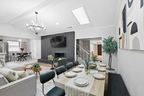 a living room with a table and a living room with a fireplace at Spacious 5BR Getaway with Pool in Duncanville
