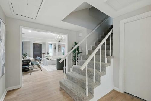 a white hallway with stairs in a home at Spacious 5BR Getaway with Pool in Duncanville