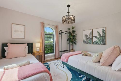 two beds in a room with a window at Spacious 5BR Getaway with Pool in Duncanville