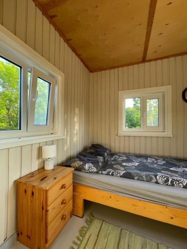 a bedroom with a bed and two windows at Tooraku Turismitalu in Pusku