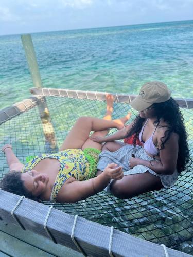 two women laying on a net near the water at Casa Acuarimantima in Tintipan Island