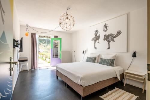 a bedroom with a bed and a chandelier at Apartment Hotel Zuid Oost Heesterveld BnB ZOH in Amsterdam