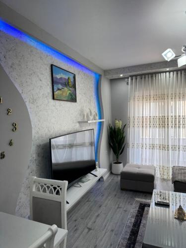 a living room with a flat screen tv on a wall at Eriksens Apartment in Pogradec