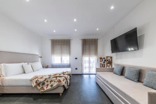 a bedroom with a bed and a couch at NG Guest House il Gallura in Olbia