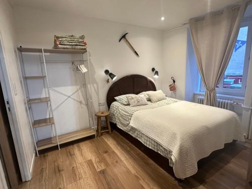 a bedroom with a bed and a book shelf at Aroma Cite Vauban in Briançon