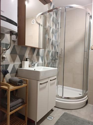 a bathroom with a sink and a shower at Divci Nova1- A8 in Divčibare