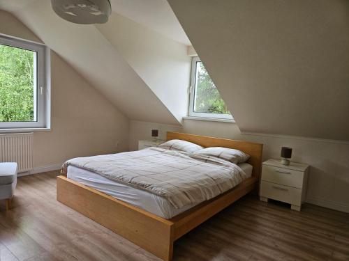 a bedroom with a bed and two windows at Sielskie Sitno in Sitno