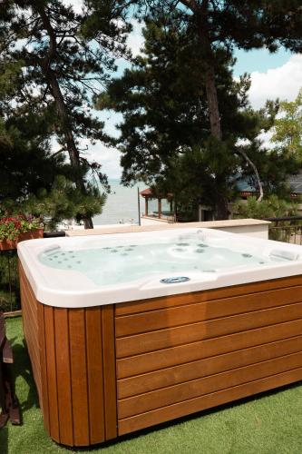 a jacuzzi tub in a yard with a beach at Royal Mediterran in Siófok