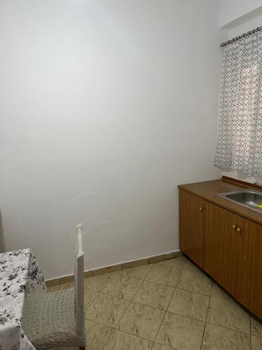 a kitchen with a sink and a counter top at Vila Rapo in Himare