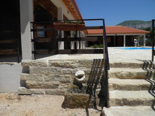 a statue sitting on the steps of a building at Agroturizam Duvančić - Konoba dida Marka in Drniš