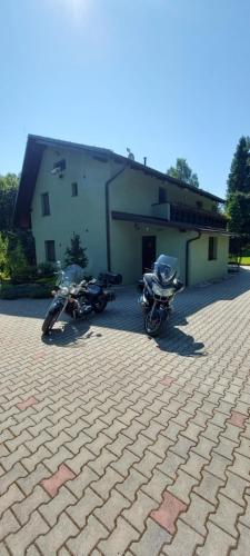 two motorcycles parked in front of a building at Chata Bella in Smižany