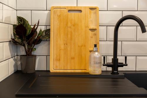 a bottle of soap sitting next to a kitchen sink at The Flat - Brand new renovation in amazing location in St. Agnes