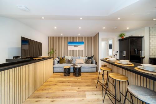 a kitchen and living room with a couch at The Flat - Brand new renovation in amazing location in St. Agnes