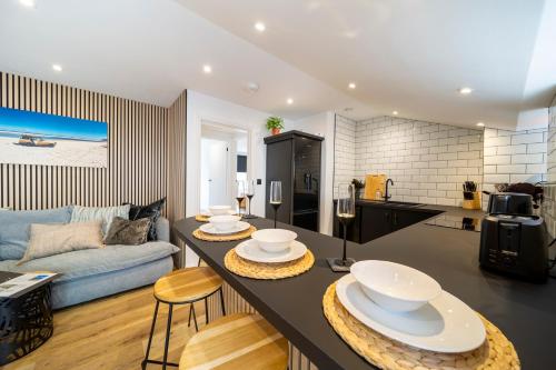 a kitchen and living room with a table and chairs at The Flat - Brand new renovation in amazing location in St. Agnes