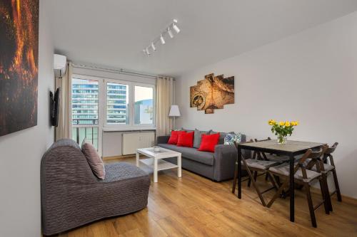 a living room with a couch and a table at Vorto Apartament 4 - Warszawa Centrum in Warsaw