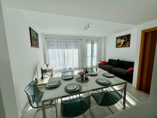 a living room with a table and a couch at Triplex con vistas al mar junto al campo de golf de Calanova in Mijas Costa