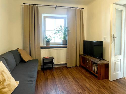 a living room with a couch and a television at Zielona 5 in Lublin