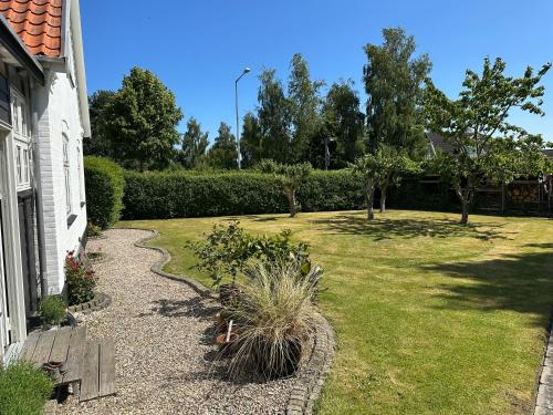 a house with a garden and a yard with plants at Revninge Guesthouse in Revninge